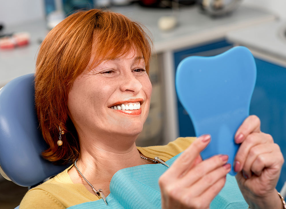 Woman smiling into mirror